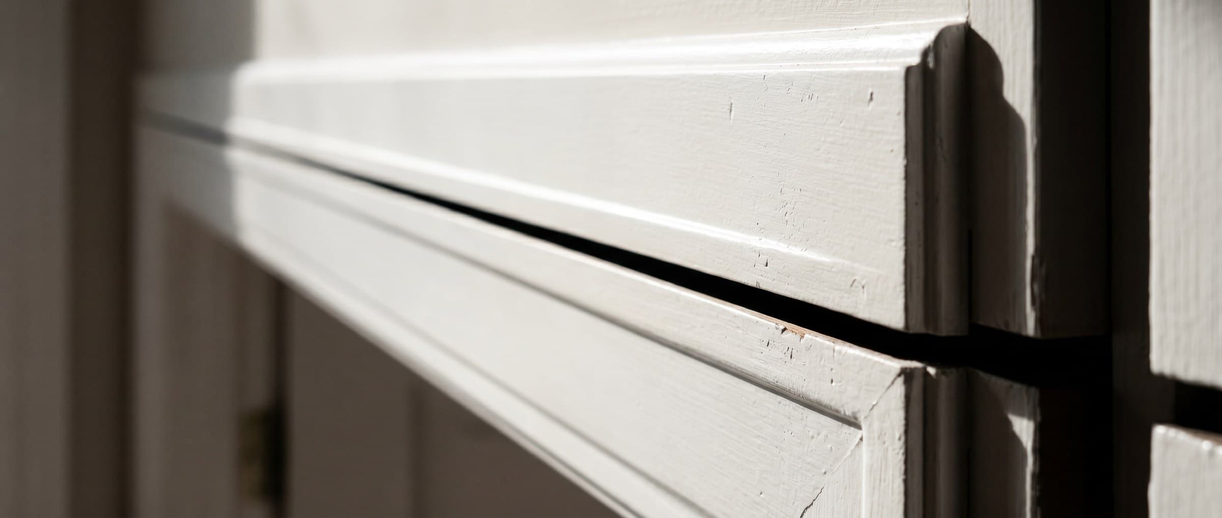 Raking light across a finished door casing with a perfectly even reveal